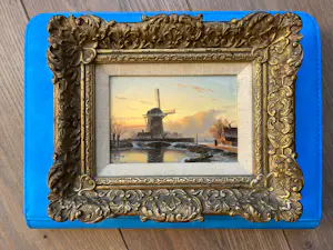 Anton Karssen - Winters landschap met vrouw op een pad bij een molen kopen? Bied vanaf 390!