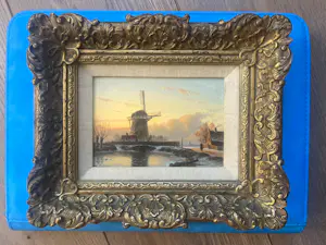 Anton Karssen - Winters landschap met vrouw op een pad bij een molen kopen? Bied vanaf 390!