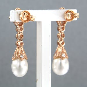 14k rosé gouden oorhangers bezet met parel en 8 kant geslepen diamant tot.0.34ct kopen? Bied vanaf 440!