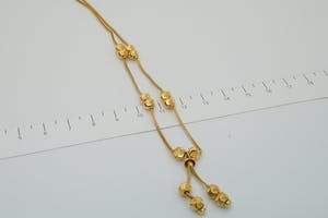 2524 - Stijlvol 18 karaats geel-gouden dames Dokiya "balletjes" halssieraad. kopen? Bied vanaf 220!